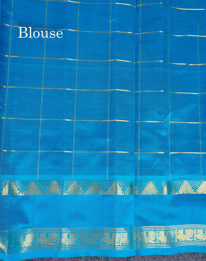 Pure Silk Cotton Saree - Dual Tone Violet Checks With Traditional Butta Along With Contrast Ramar Blue Traditional Gap Border