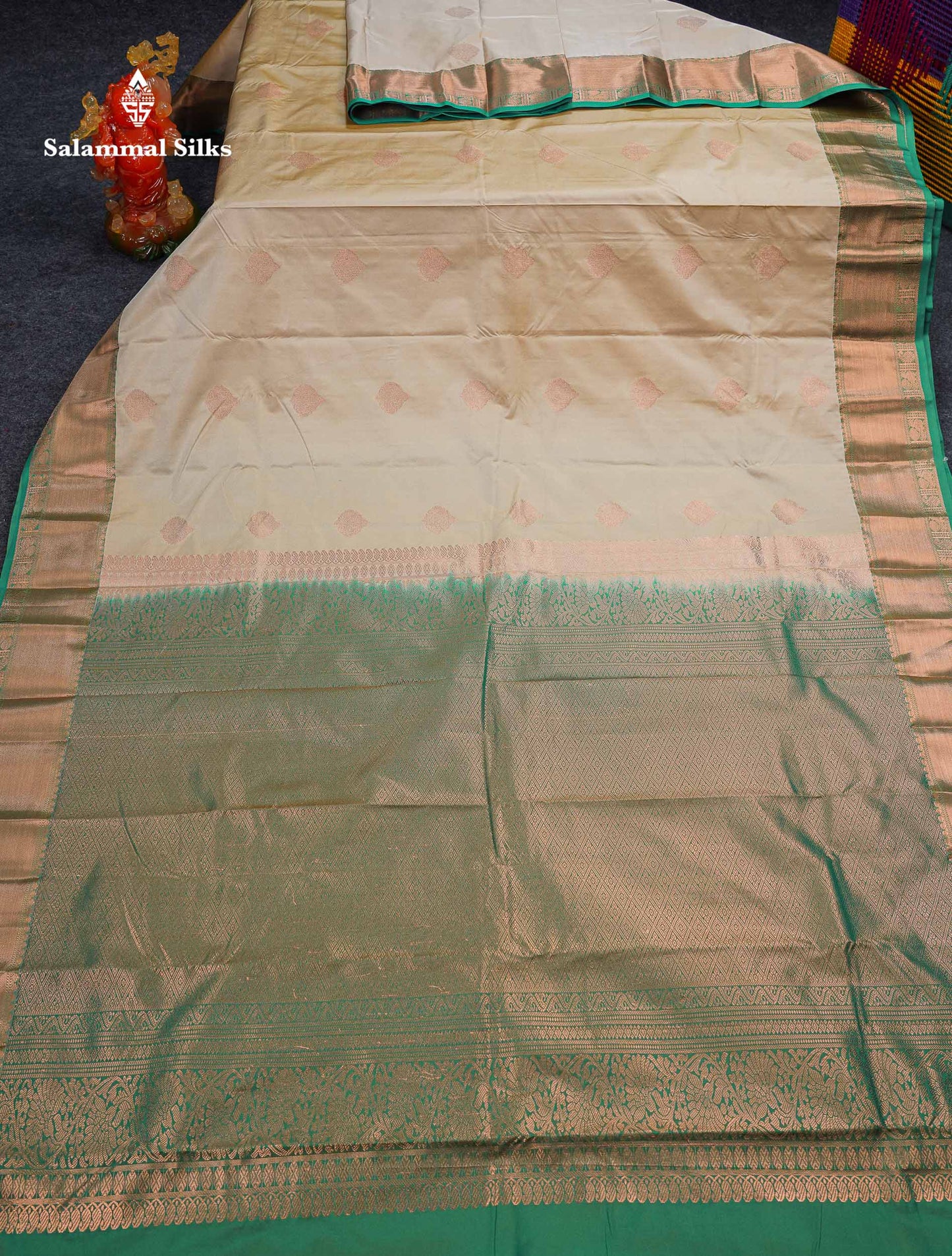 Beautiful Cream Sandal Zari Butta Semi Silk Saree With Contrast Sapphire Green Traditional Border