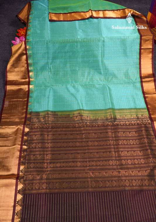 Pure Silk Cotton Dual Tone Sea Green Traditional Checks And Gold Silver Zari Lakshadeepam Buttas With Brown Border