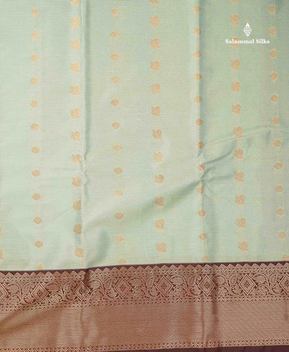Beautiful Light Elaichi Green Vaira Oosi Lines With Traditional Buttas Semi Silk Saree With Contrast Dark Brown Border