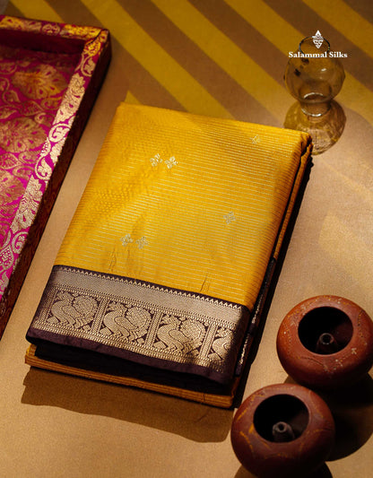 Semi Silk Saree -  Mustard Yellow Butta With Vaira Oosi Lines Along With Contrast Dark Brown Small Traditional Border