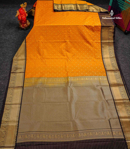 Semi Silk Saree - Mango Yellow Butta With Small Checks Along With Contrast Dark Brown Iruthala Pakshi Traditional Border