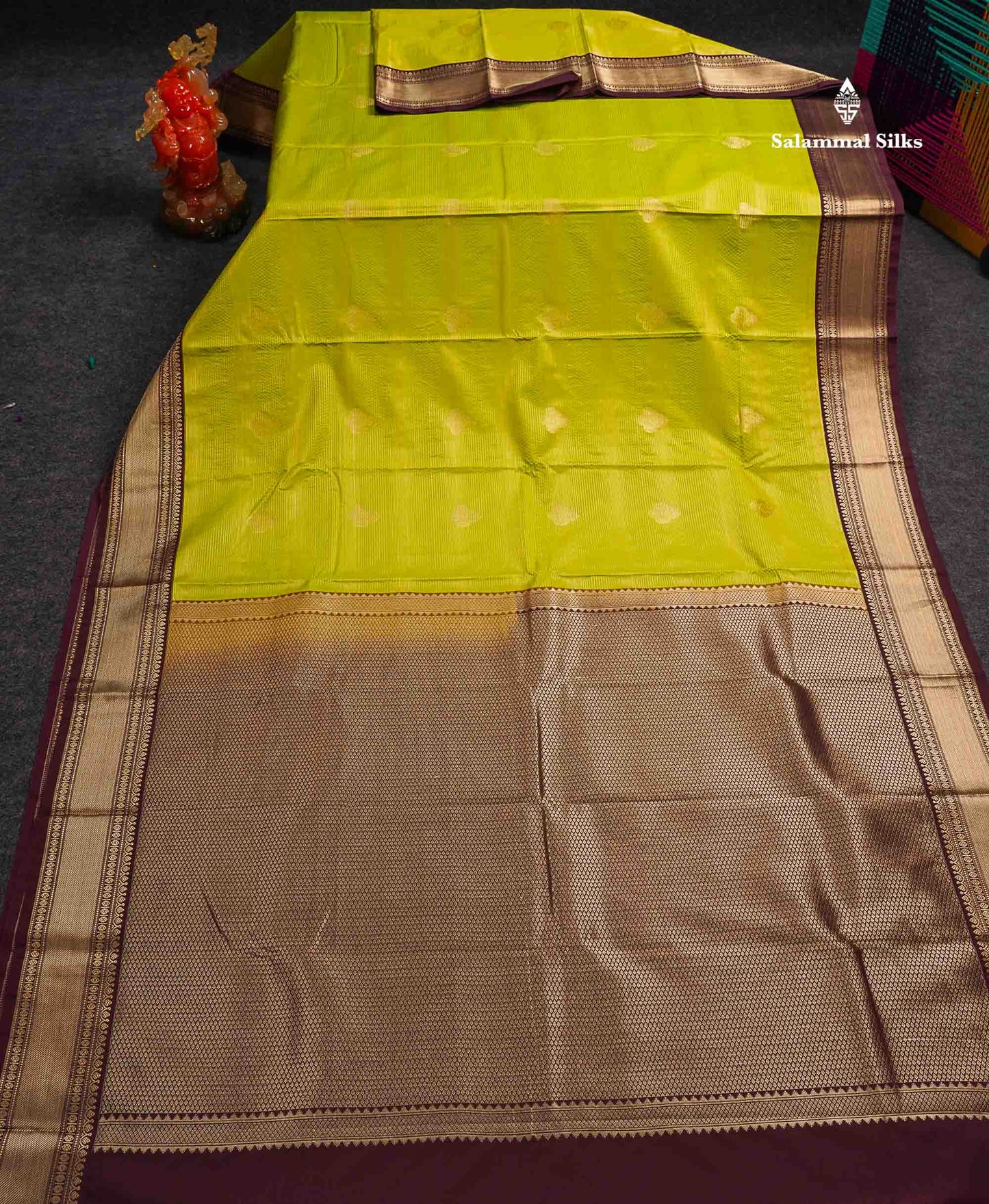 Semi Silk Saree - Parrot Green Alai Vaira Oosi Lines With Butta Along With Contrast Dark Brown Traditional Border