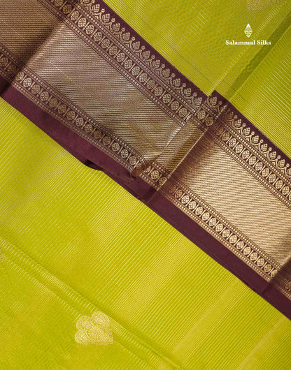 Semi Silk Saree - Parrot Green Alai Vaira Oosi Lines With Butta Along With Contrast Dark Brown Traditional Border