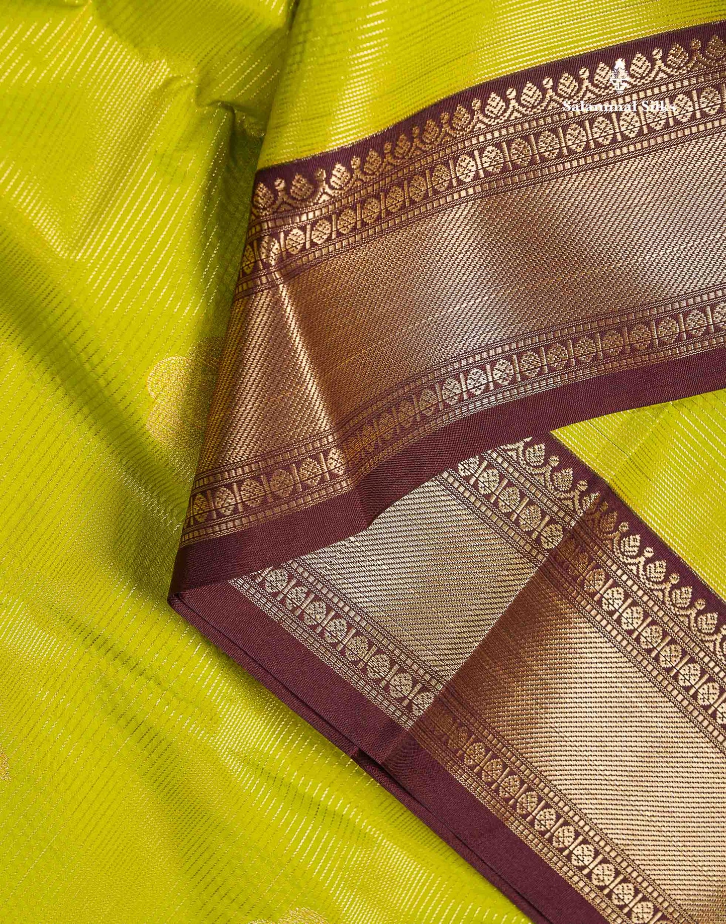 Semi Silk Saree - Parrot Green Alai Vaira Oosi Lines With Butta Along With Contrast Dark Brown Traditional Border