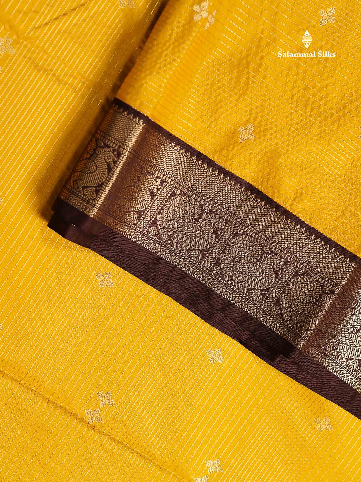 Semi Silk Saree -  Mustard Yellow Butta With Vaira Oosi Lines Along With Contrast Dark Brown Small Traditional Border