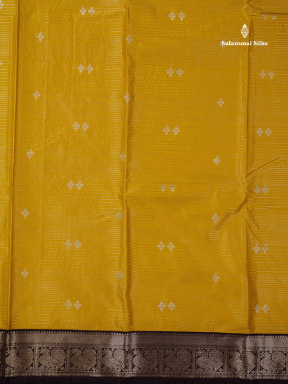 Semi Silk Saree -  Mustard Yellow Butta With Vaira Oosi Lines Along With Contrast Dark Brown Small Traditional Border